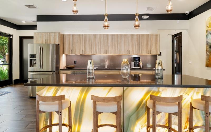 a kitchen with a bar and chairs